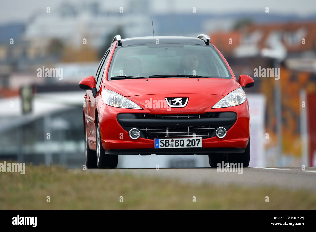 Peugeot 207 SW 120 VTi Sport, red, model year 2006-, driving, diagonal from the front, frontal view, road Stock Photo