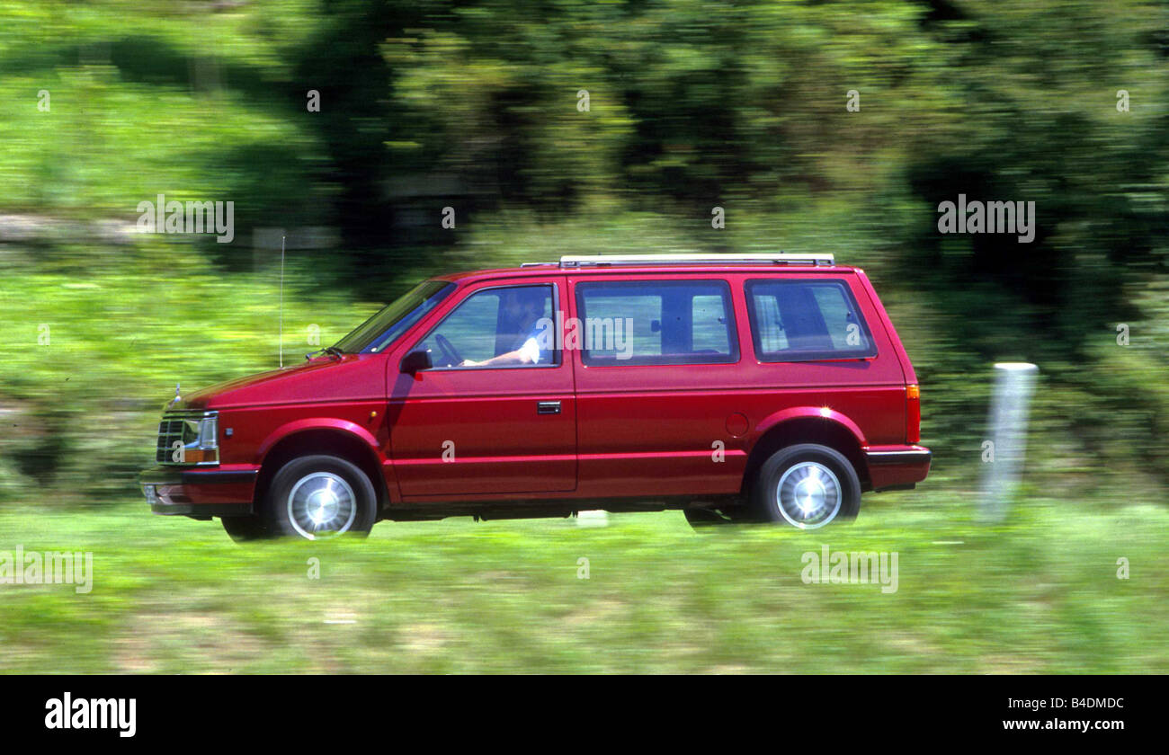 Car, Chrysler Voyager, Van, model year 1984-1995, red/ruby colored, driving, country road, side view Stock Photo