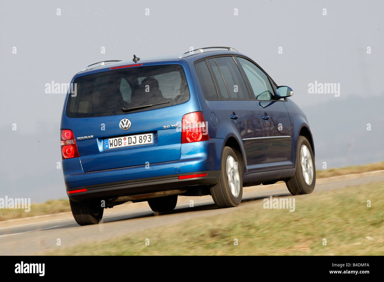 storm premier deuropening VW Volkswagen Touran 2.0 TDI Highline, model year 2007-, blue moving,  diagonal from the back, rear view, country road Stock Photo - Alamy