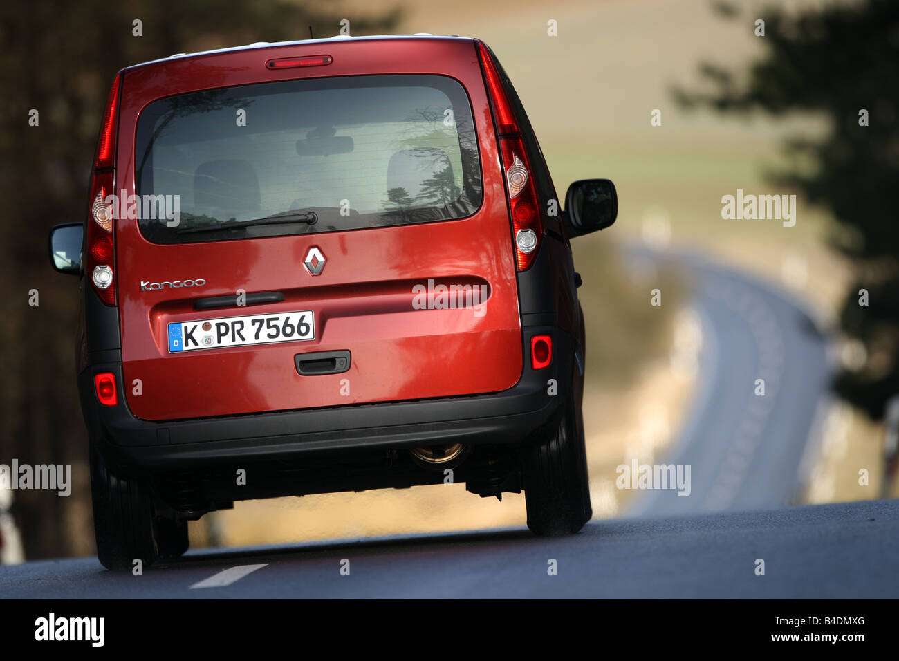 Renault Kangoo 1.6 16V, model year 2008-, ruby colored, driving, diagonal from the back, rear view, country road Stock Photo