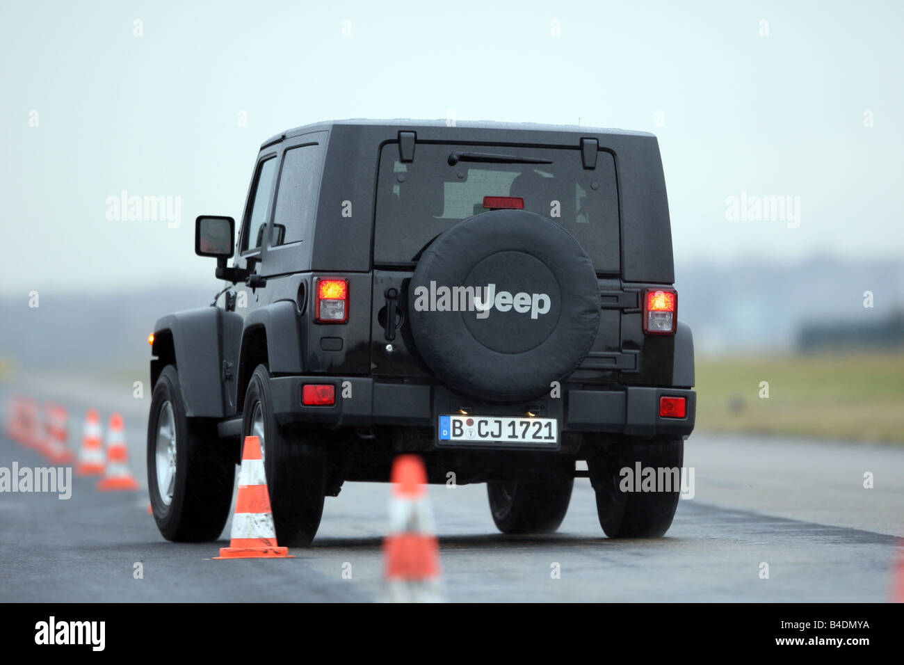 Jeep Wrangler Rubicon , model year 2008-, black, driving, diagonal from  the back, rear view, Pilonen, test track Stock Photo - Alamy