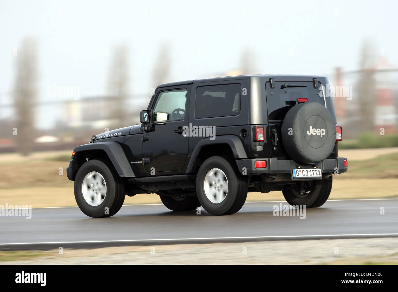 Jeep Wrangler Rubicon , model year 2008-, black, driving, diagonal from  the back, rear view, country road Stock Photo - Alamy