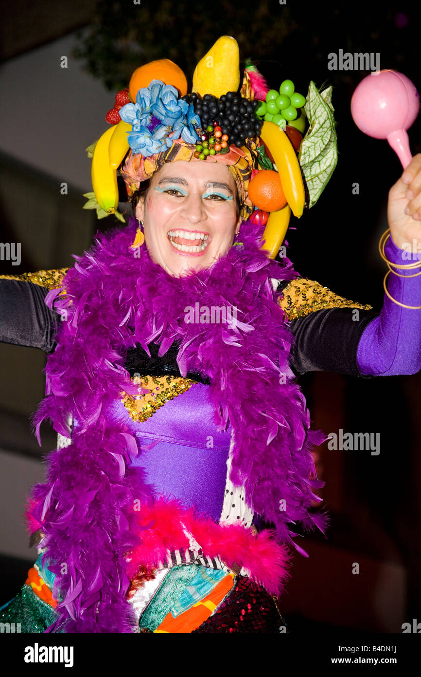 A joyful carnival entertainer helps the crowds have fun at a street