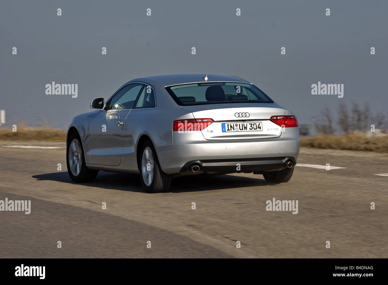 Audi A5 coupe 2.7 TDI, model year 2007-, silver, driving, diagonal from the back, rear view, country road Stock Photo