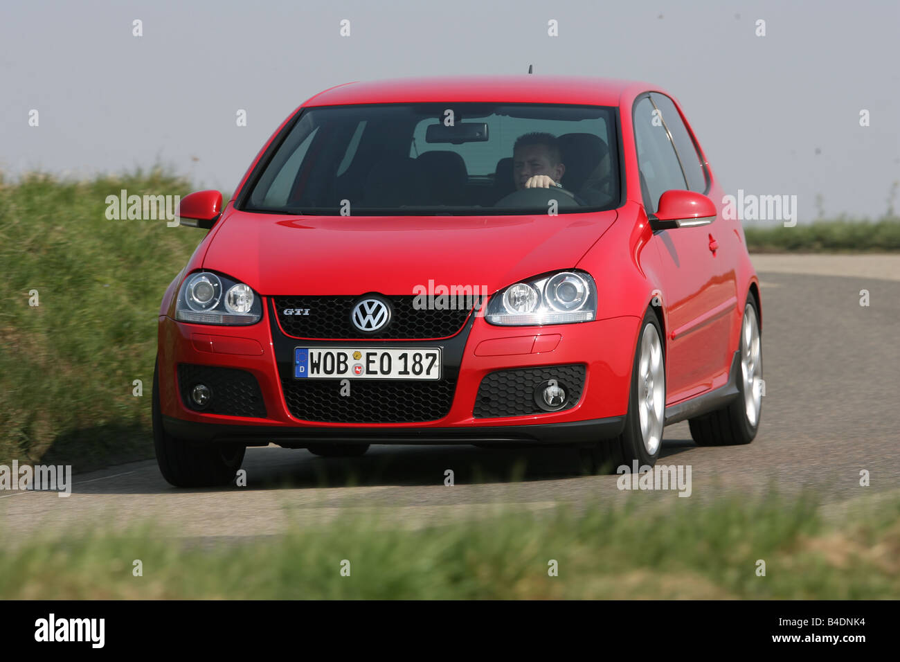 VW Volkswagen Golf GTI, model year 2004-, red, driving, diagonal from the front, frontal view, country road Stock Photo