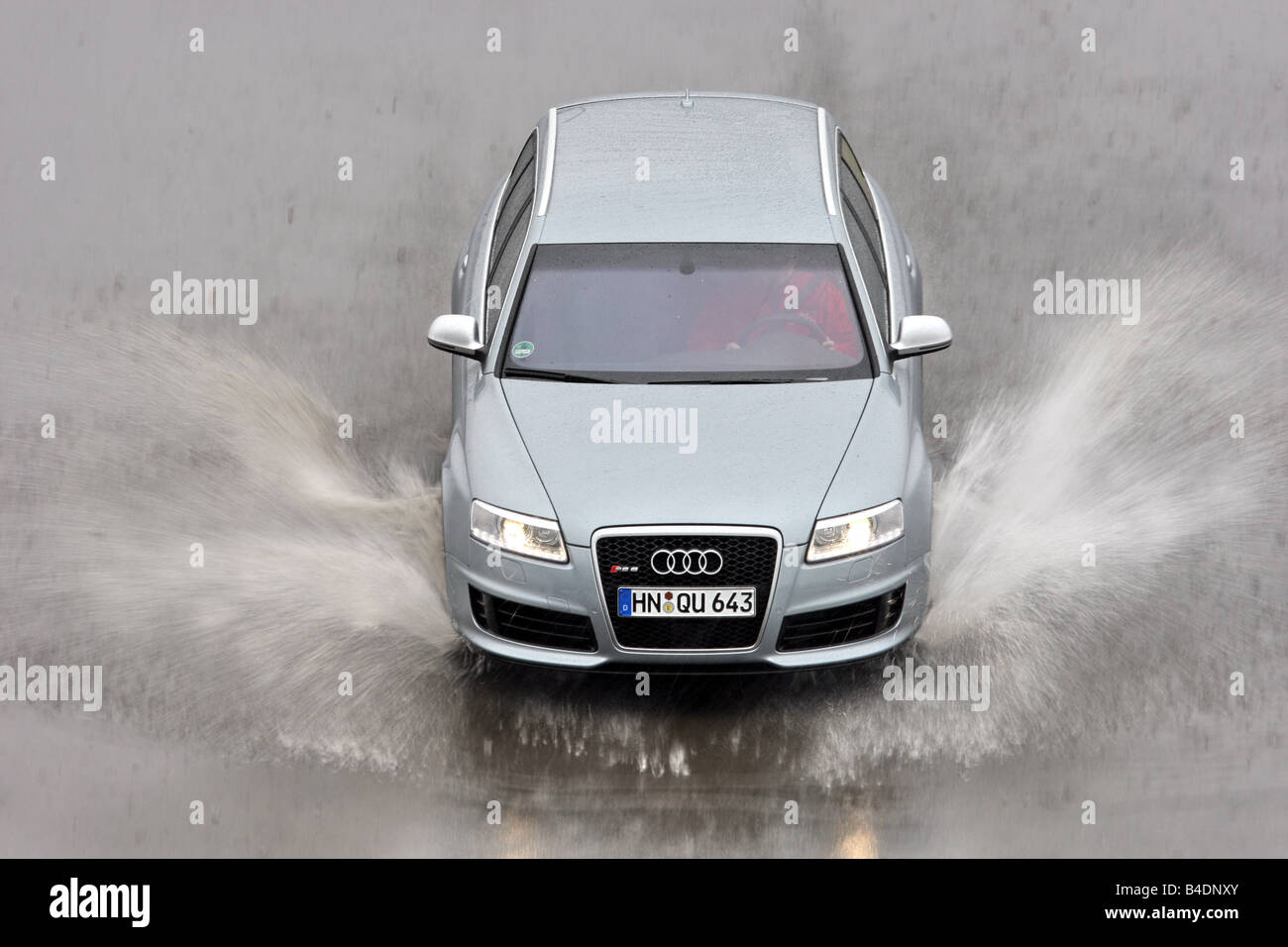 Audi RS6 Avant, model year 2008-, silver, driving, frontal view, test track, Water, Aquaplaning Stock Photo