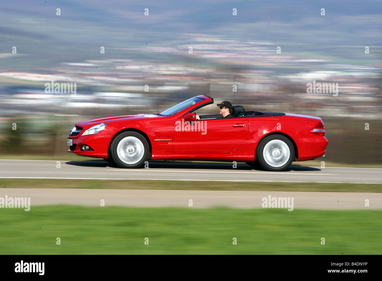Mercedes SL 350, model year 2008-, red, driving, side view, country road, open top Stock Photo