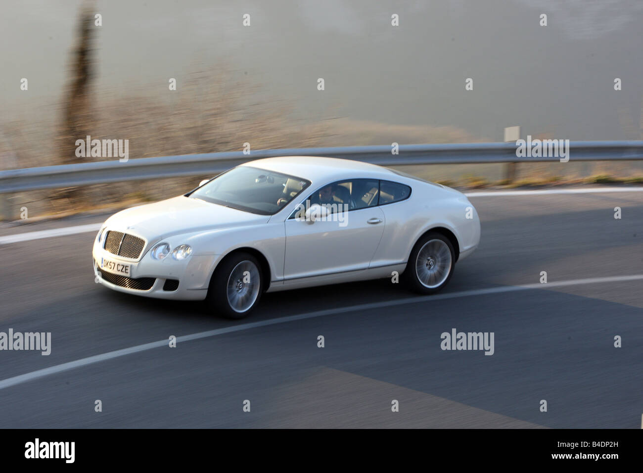 Bentley Continental GT Speed, model year 2008-, white, driving, diagonal from the front, side view, country road Stock Photo