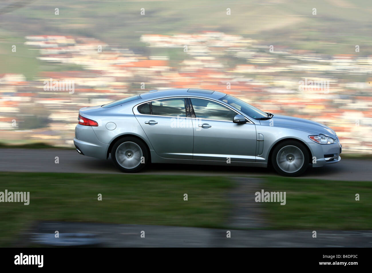 Jaguar XF 2.7 diesel engine Luxury, model year 2008-, silver, driving, side view, country road Stock Photo