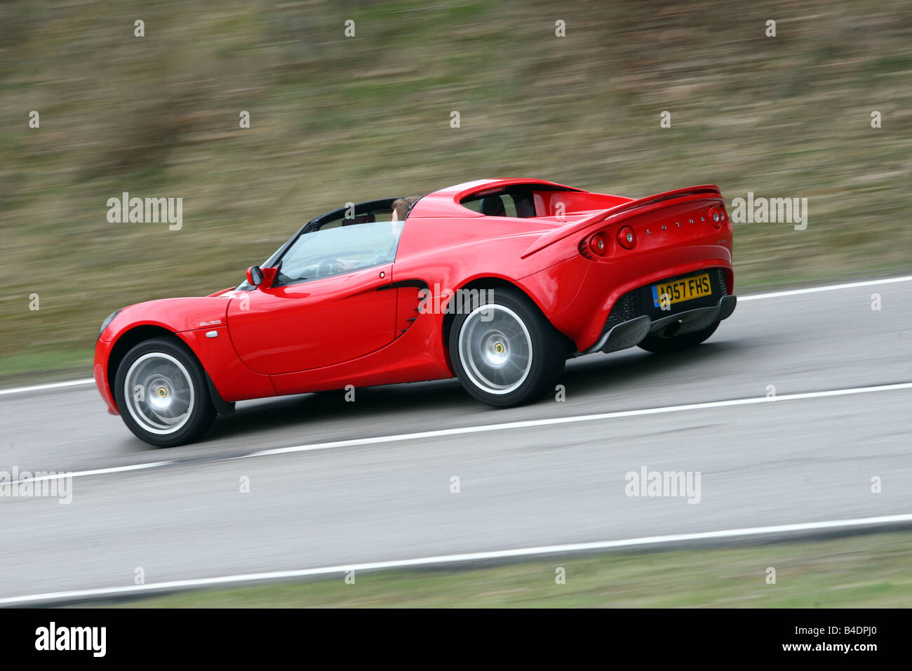 Lotus Elise SC, model year 2008-, red, driving, diagonal from the back