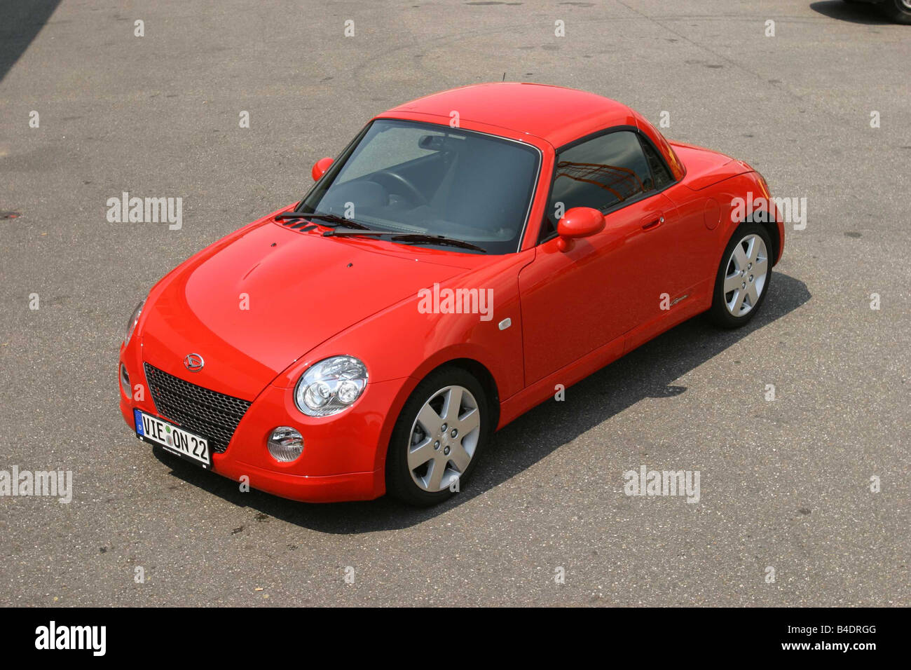 Car, Daihatsu Copen, Convertible, model year 2003-, red-orange , closed top, standing, upholding, diagonal from the front/oben Stock Photo
