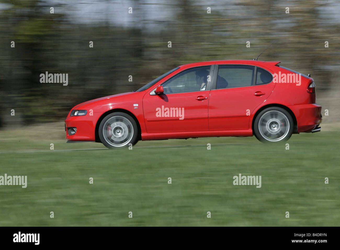 Car, Seat Leon Sport , Lower middle-sized class, Limousine, model year 1999-, red, driving, country road, side view Stock Photo