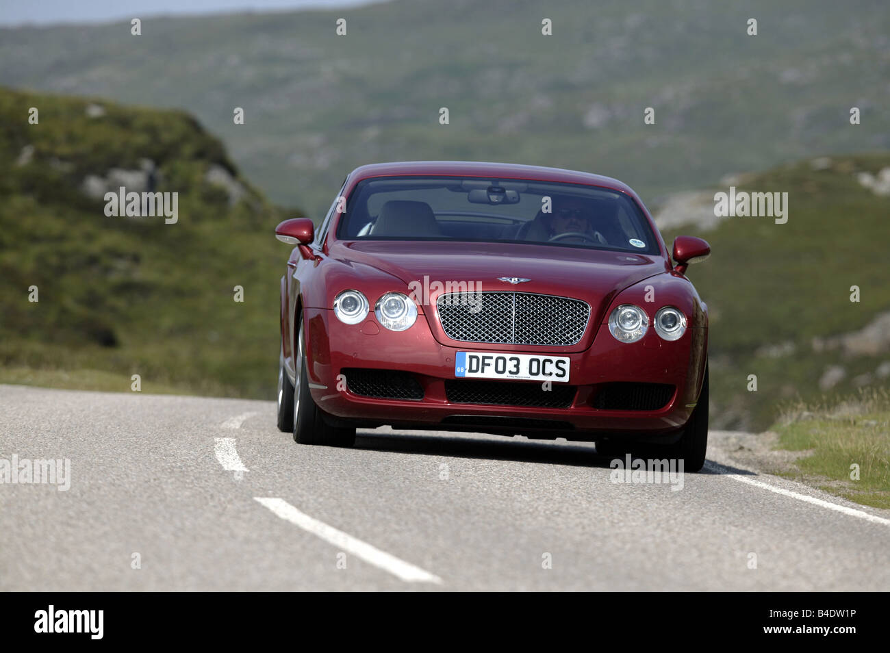 Car, Bentley Continental GT, model year 2003-, Coupe, Luxury approx.s, ruby colored, driving, country road, diagonal from the fr Stock Photo