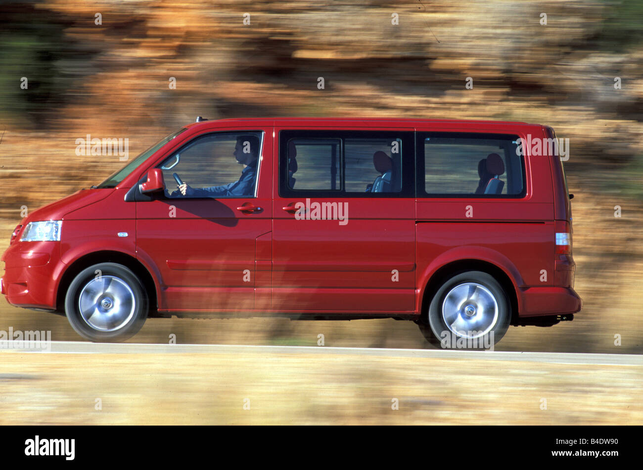 https://c8.alamy.com/comp/B4DW90/car-vw-volkswagen-multivan-t5-25-tdi-van-model-year-2003-red-driving-B4DW90.jpg