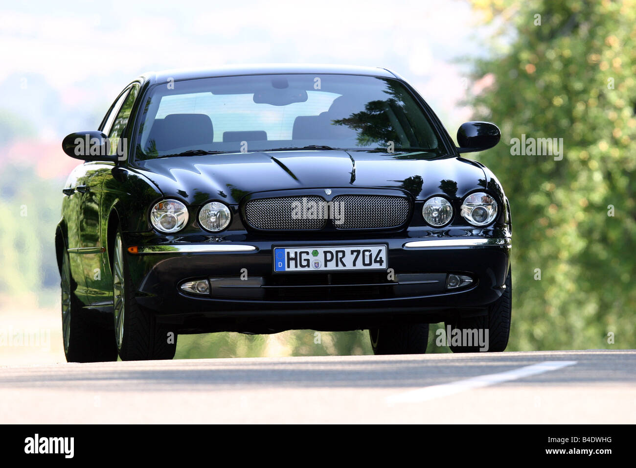 Car, Jaguar XJ R, Limousine, Luxury approx.s, model year 2003-, black, driving, country road, diagonal from the front, Front vie Stock Photo