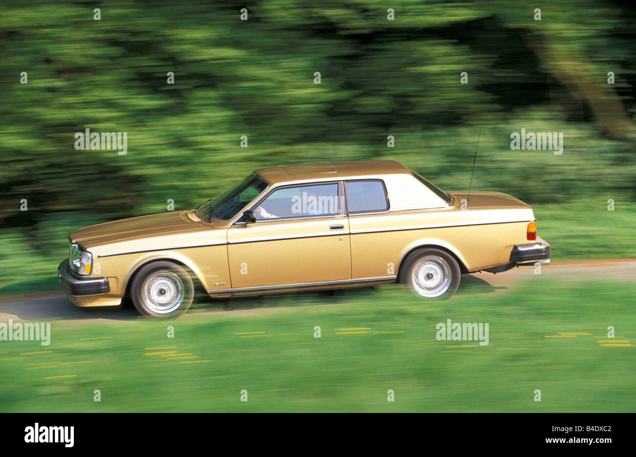 Car, Volvo 262 C, Limousine, upper middle-sized , gold, model year 1978-1981, driving, side view, country road, Bertone Stock Photo