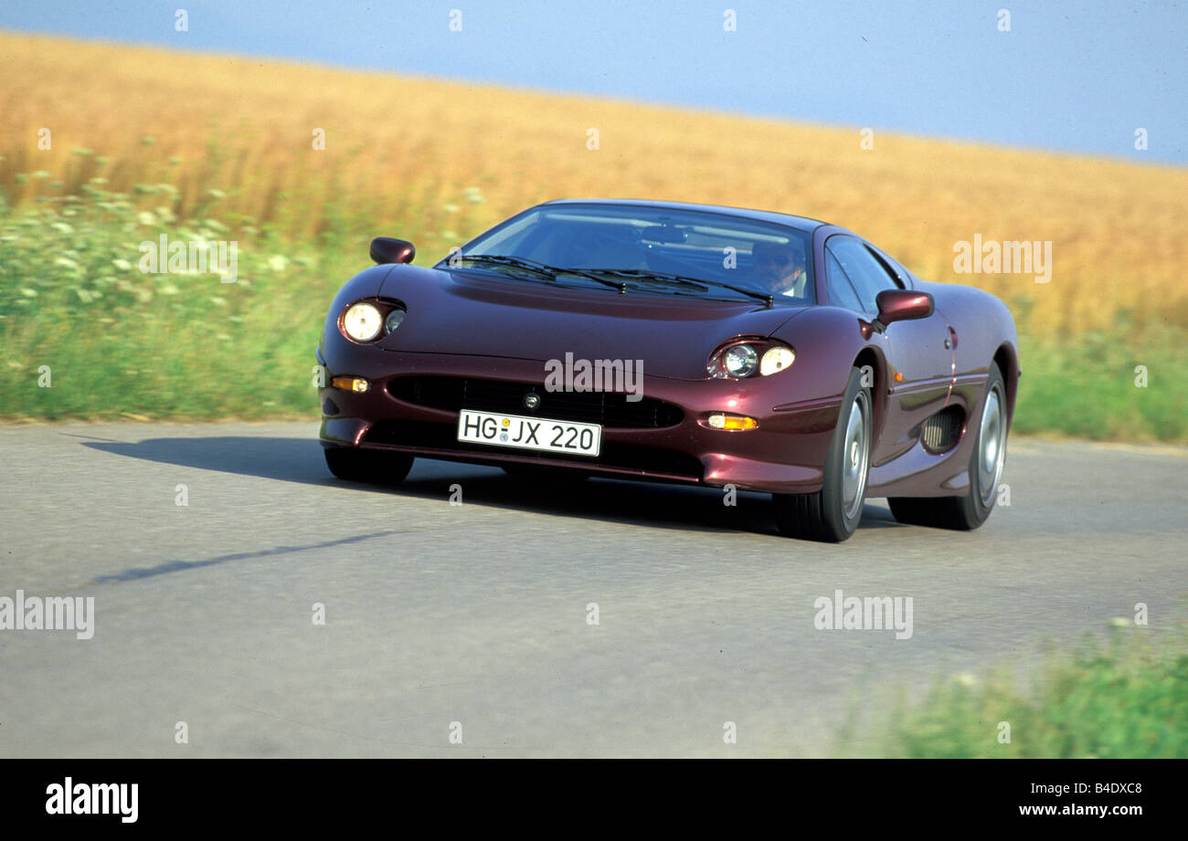 Car, Jaguar XJ 220, model year 1994, wine-red-metallic, coupe/Coupe, roadster, driving, diagonal from the front, frontal view, c Stock Photo