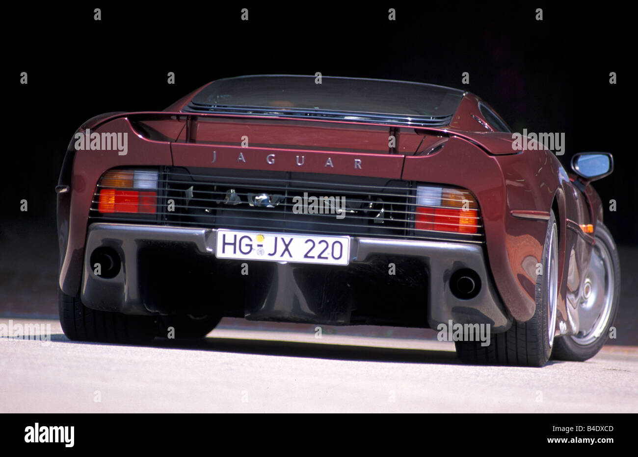 Car, Jaguar XJ 220, model year 1994, wine-red-metallic, coupe/Coupe, roadster, diagonal from the back, Rear view Stock Photo