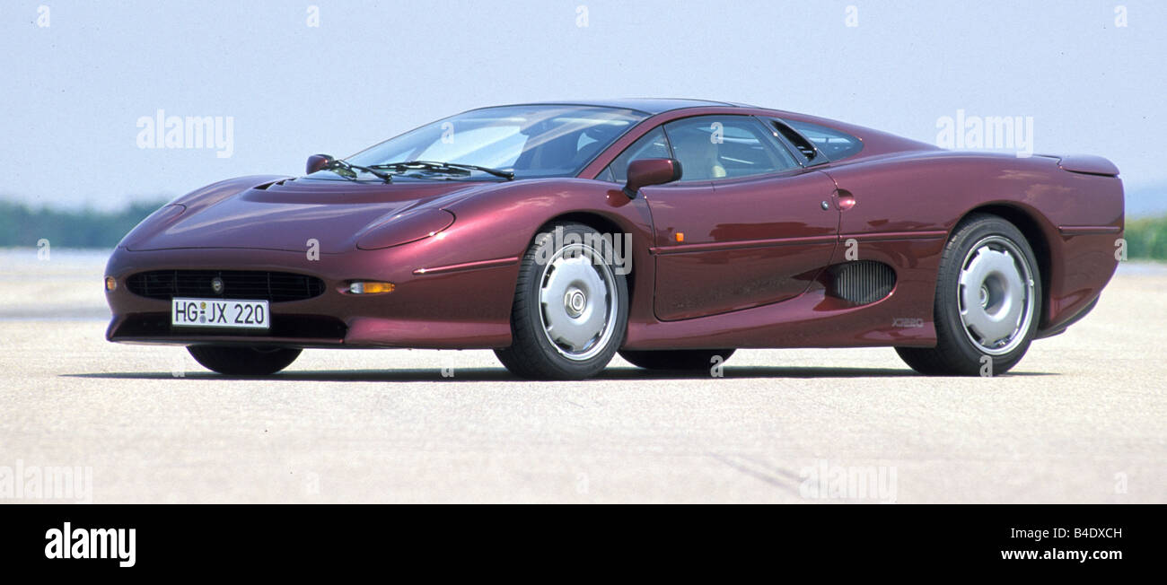 Car, Jaguar XJ 220, model year 1994, wine-red-metallic, coupe/Coupe, roadster, standing, upholding, diagonal from the front, fro Stock Photo