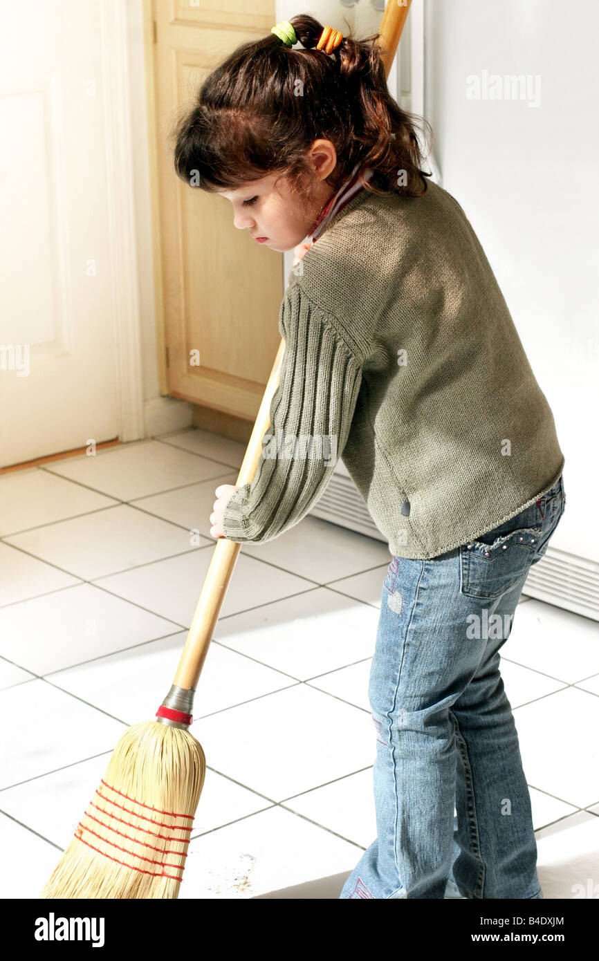 Little girl helping to clean the house Stock Photo