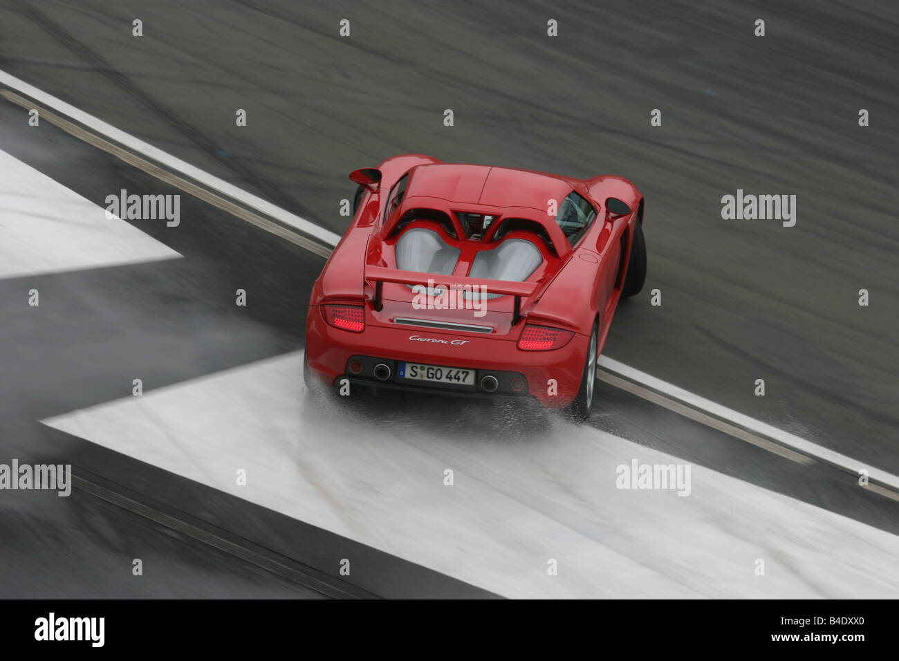 Car, Porsche Carrera GT, roadster, model year 2003-, coupe/Coupe, FGHDS, red, driving, diagonal from the back/oben, rear view, t Stock Photo