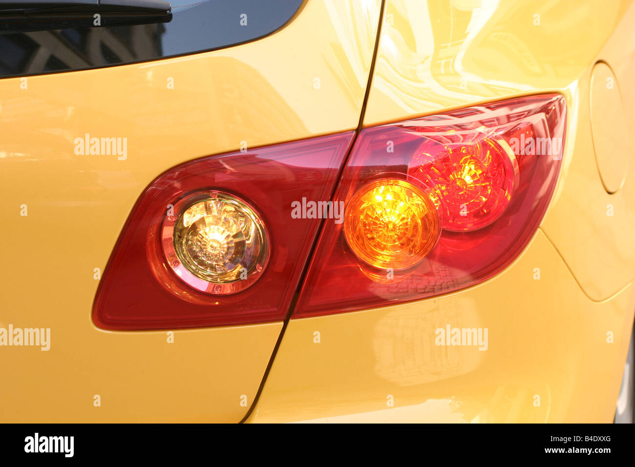 Car, Mazda 3 Sport 1.6, Lower middle-sized class, Limousine, model year 2003-, FGHDS, yellow, Detailed view, rear lamp, techniqu Stock Photo