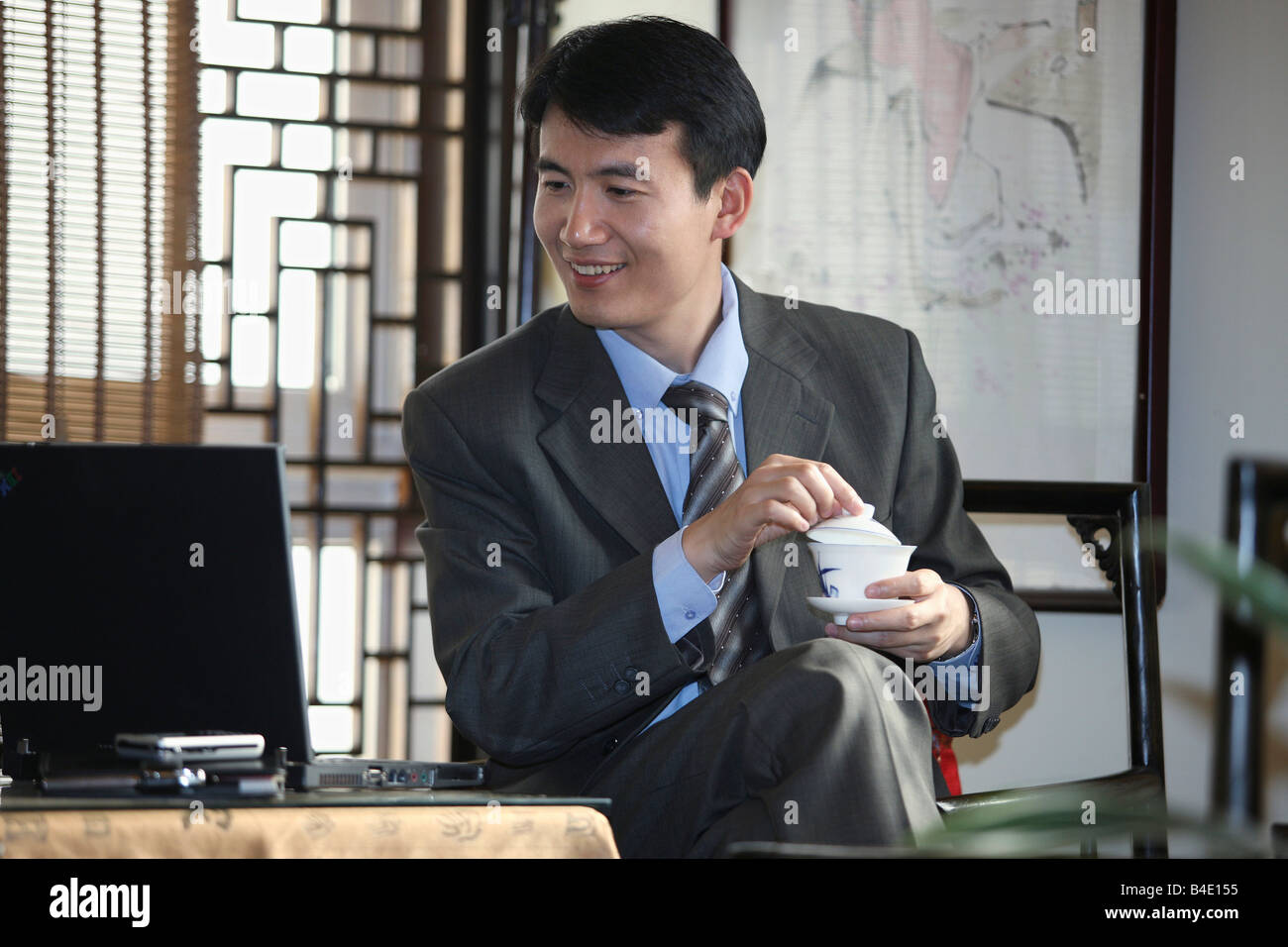 Chinese Business Man Using The Notebook PC Stock Photo