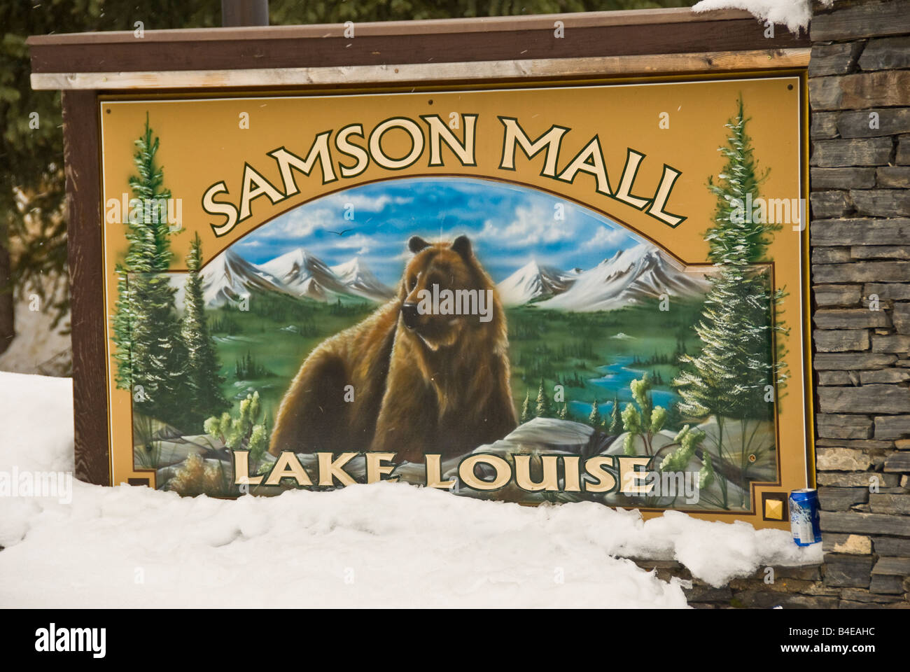 Lake Louise Canada Samson Mall sign half-buried by snow with grizzly bear, canadian shopping mall Stock Photo