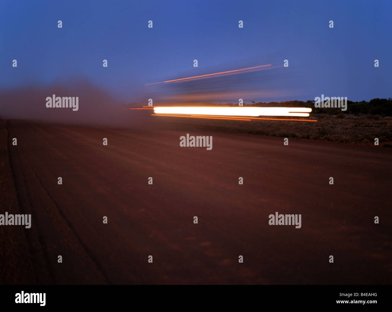 Moving Automobile Lights on Australian Outback Road Stock Photo