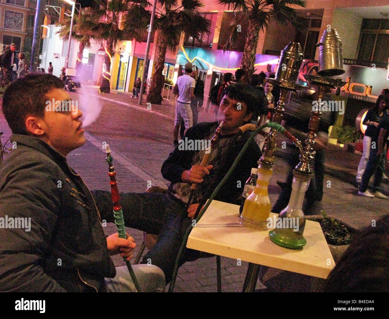 Youngs smoking waterpipe in St Julian Malta Stock Photo Alamy