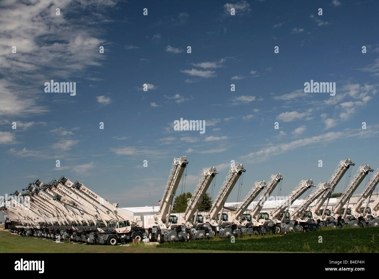 Truck mounted cranes staged for transport Stock Photo