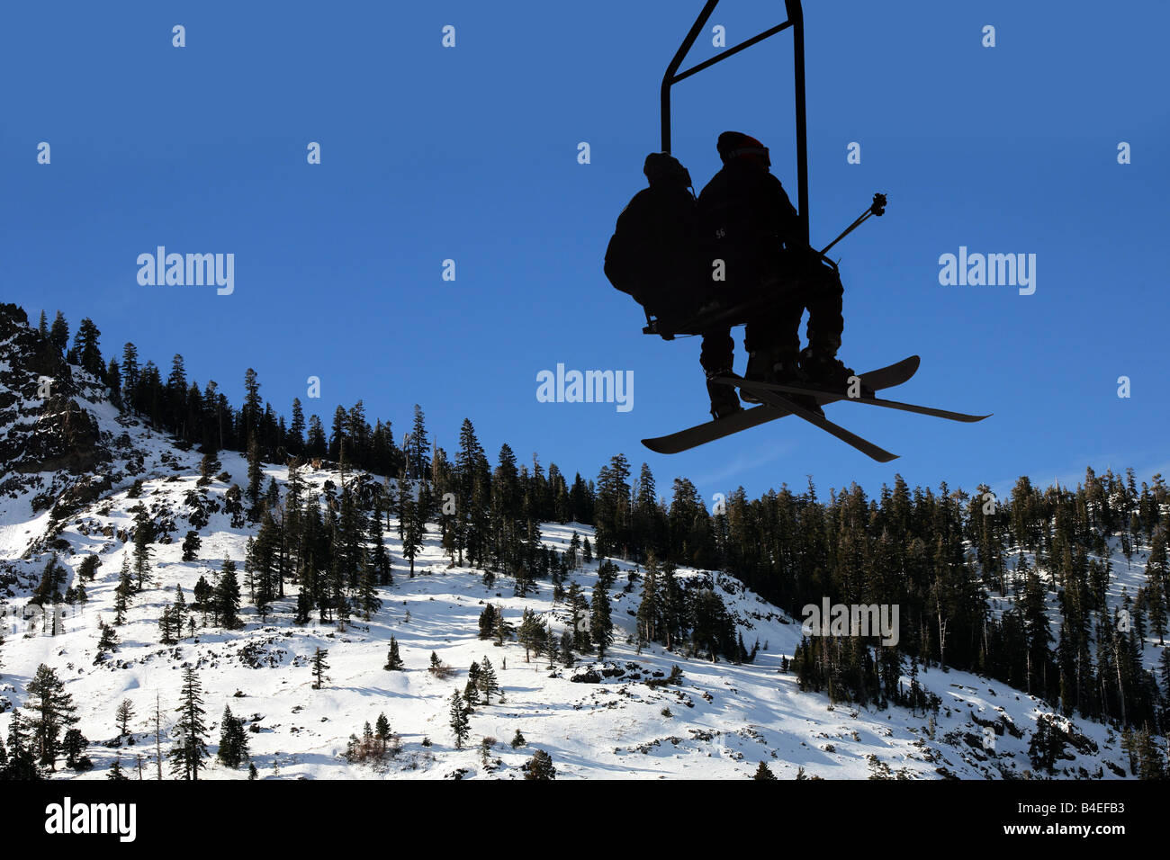 Two people on the lift at the ski resort Stock Photo - Alamy