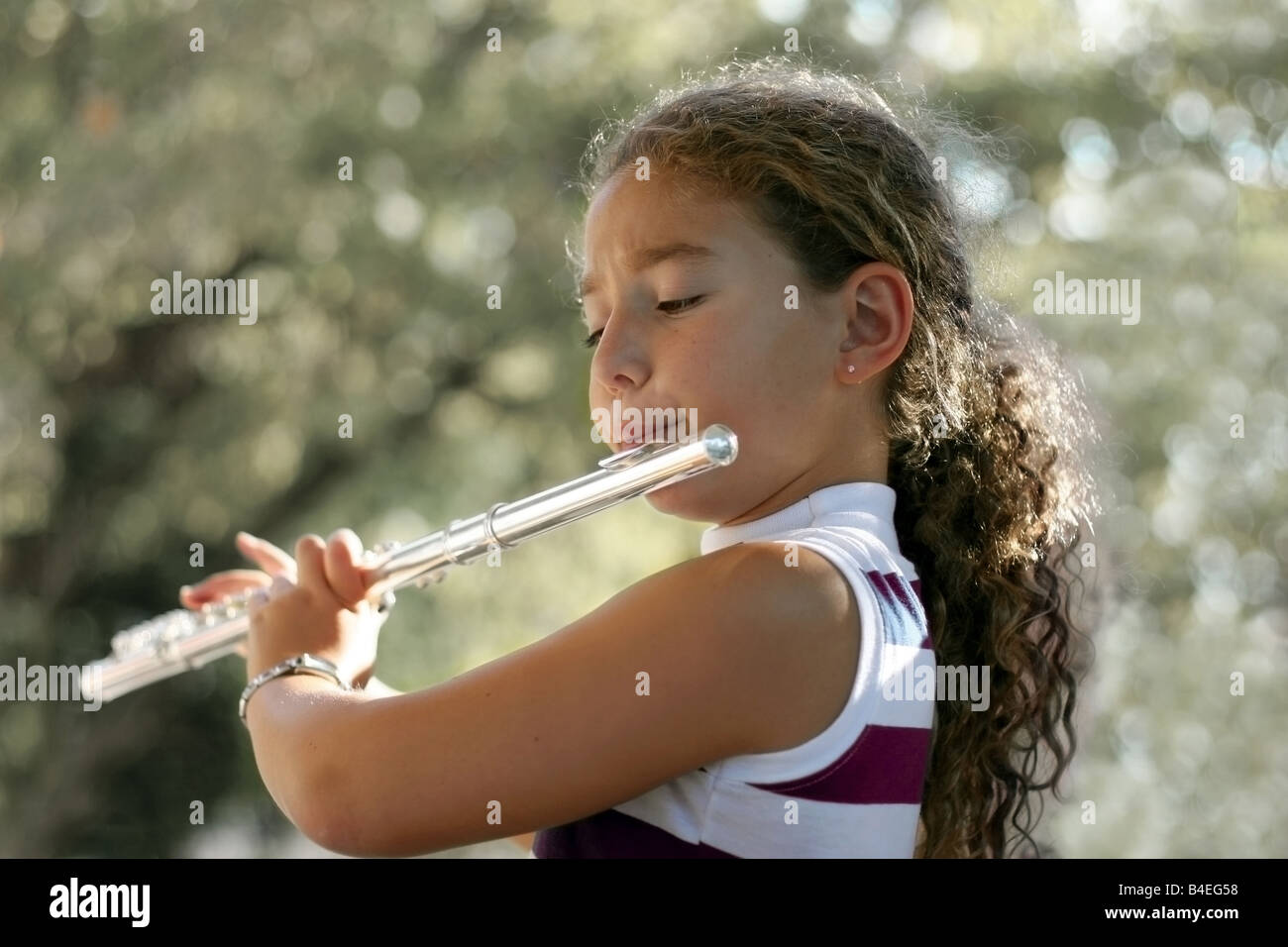 Girl playing a flute Stock Photo