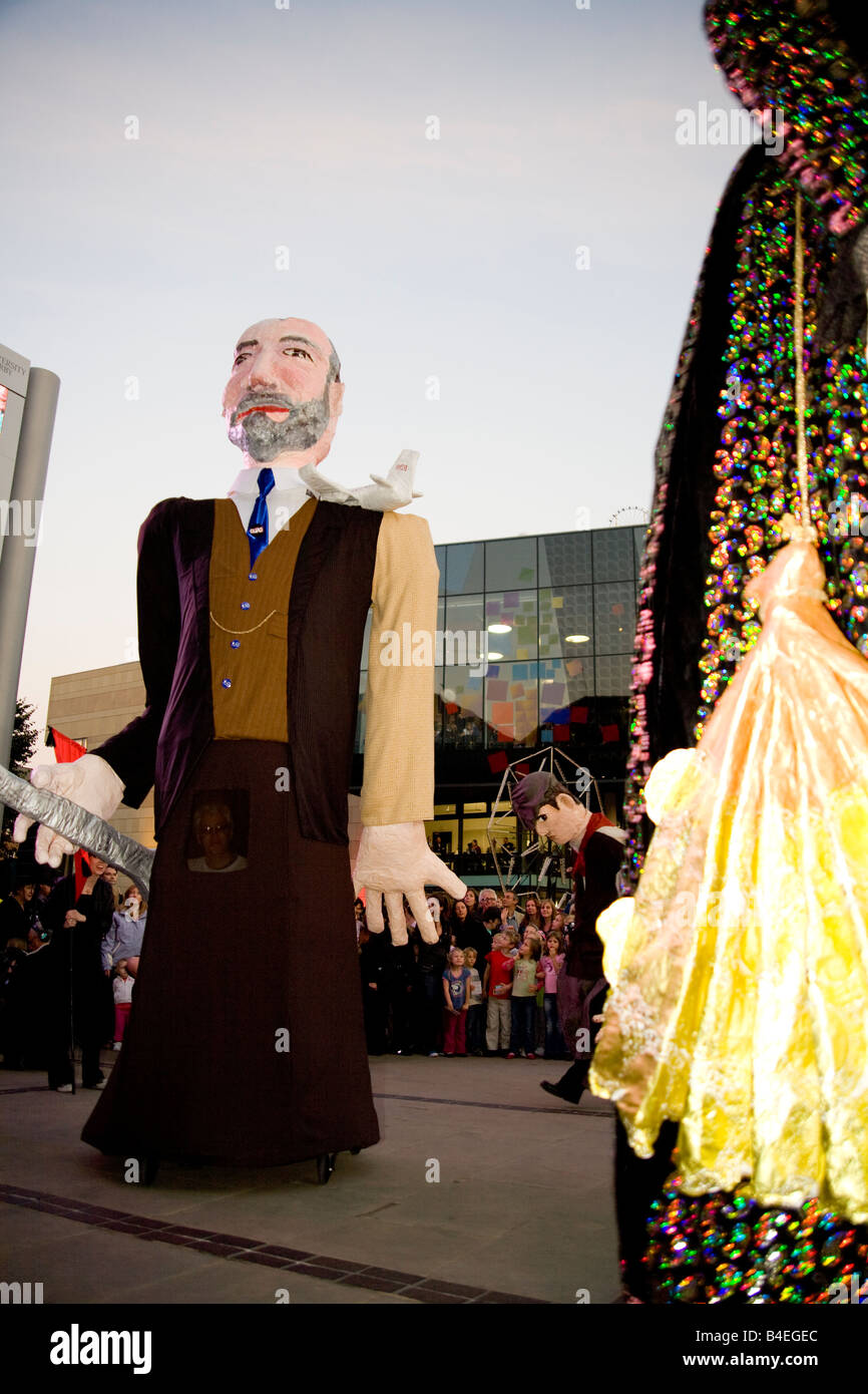 Large Papier-mache puppets and crowds in Derby City market place during the Derby Feste. Stock Photo