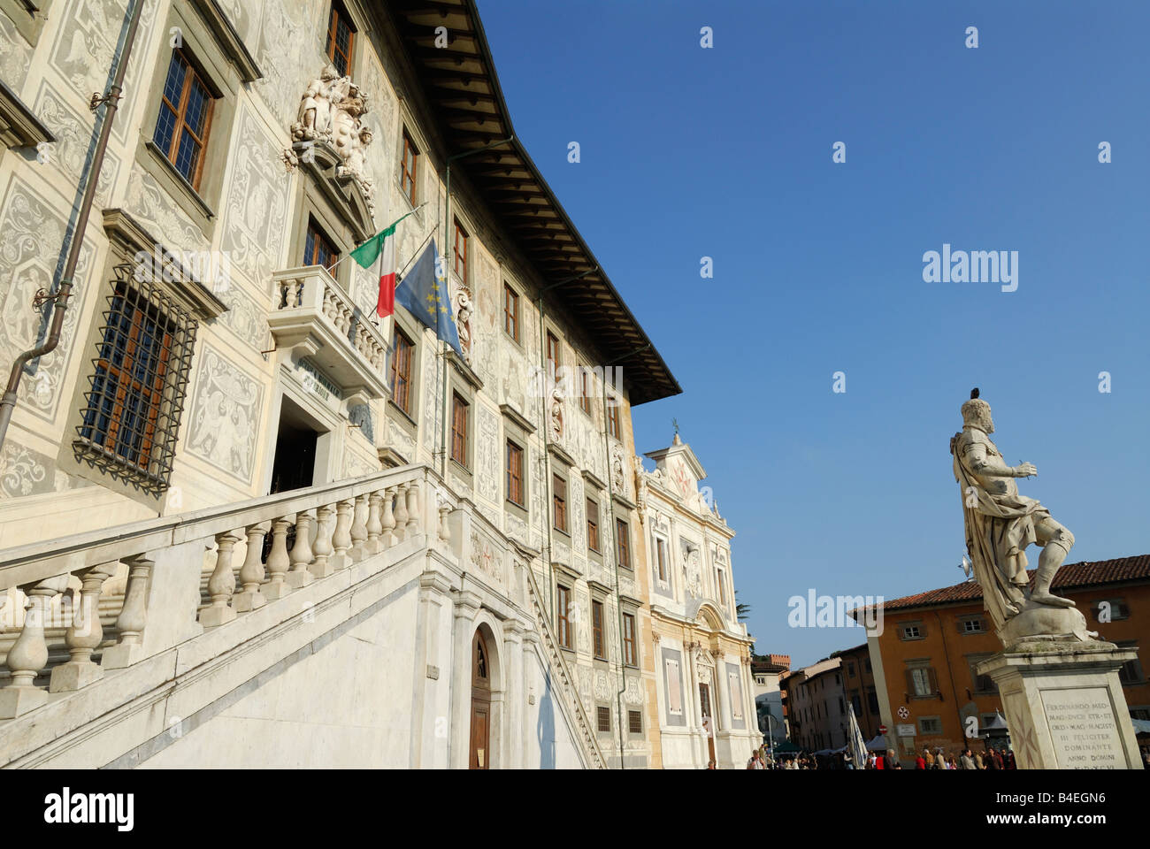 Pisa Italy Statue of Cosimo I de Medici stands infront of Palazzo della Carovana dei Cavalieri aka La Scuola Normale Superiore Stock Photo
