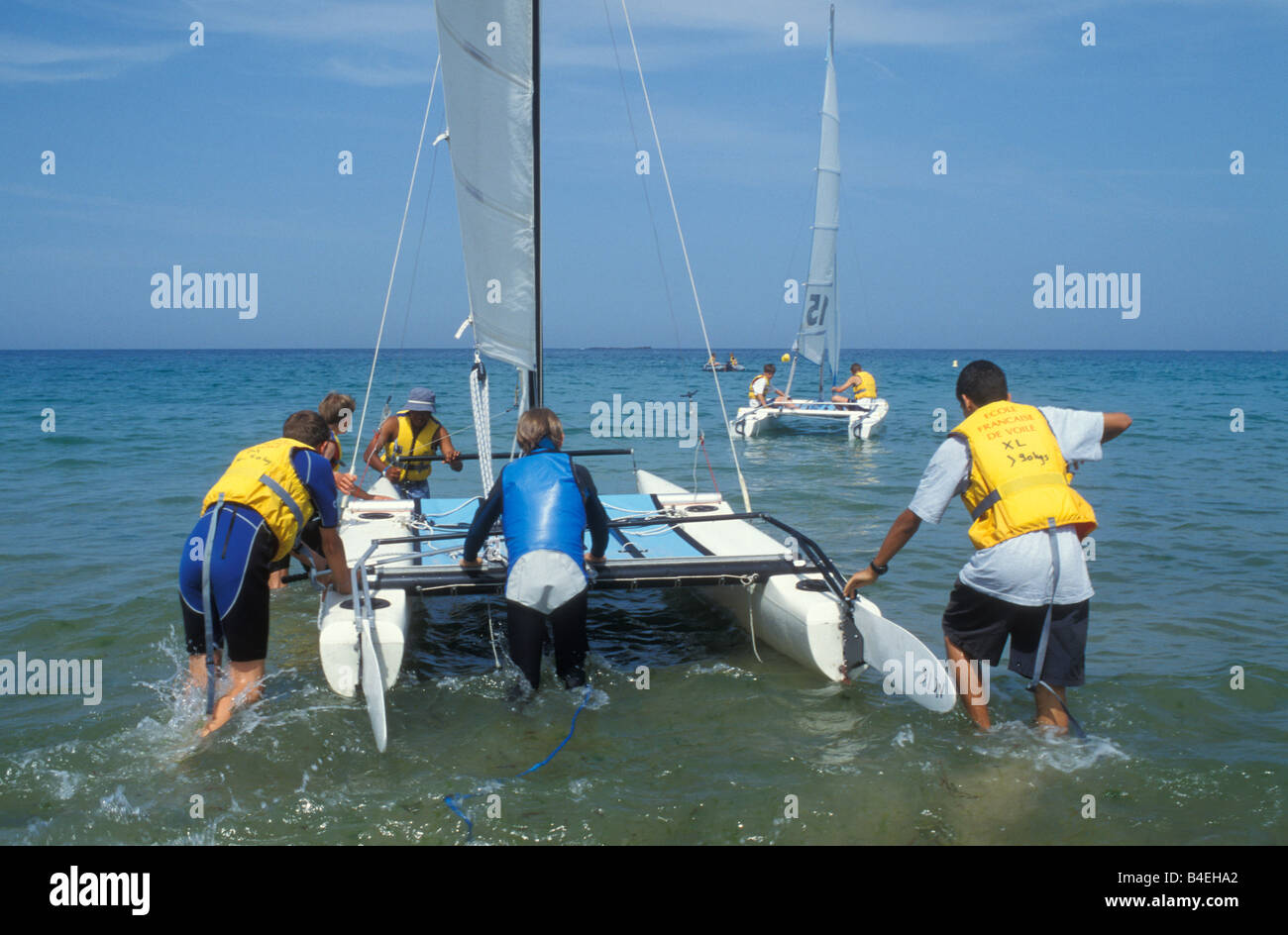 Teenagers with Sailboats at Sailing School Pleherel Plage Cote D