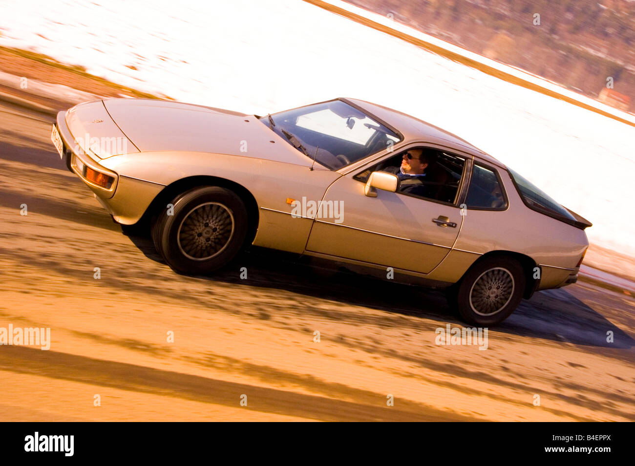 Car, Porsche 924, model year 1977, beige-metallic, Coupé ,  Coupe, old car, driving, side view, road, country road, photographer Stock Photo