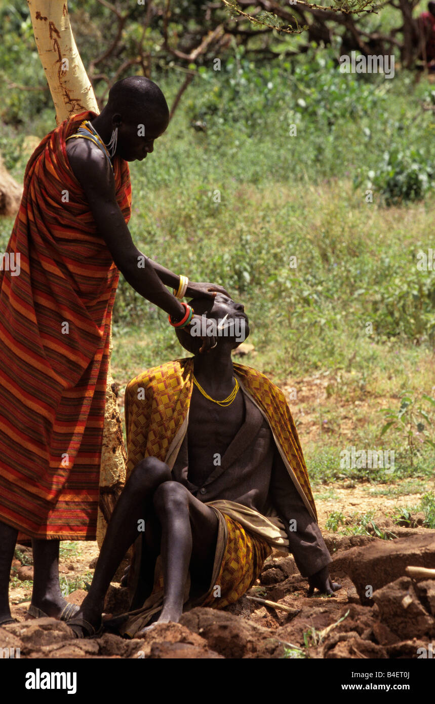 Ethnic Karamojong man getting face shave, Karamoja, Uganda Stock Photo