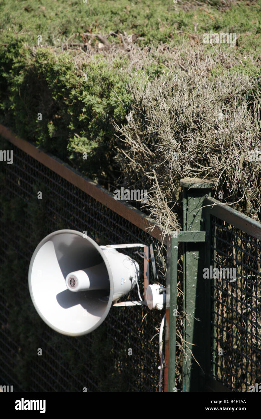 megaphone speaker on old fence outdoors Stock Photo