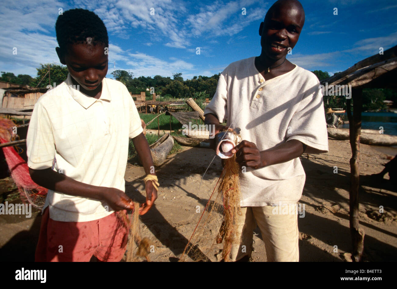 Boys preparing fishing net, Uganda Stock Photo