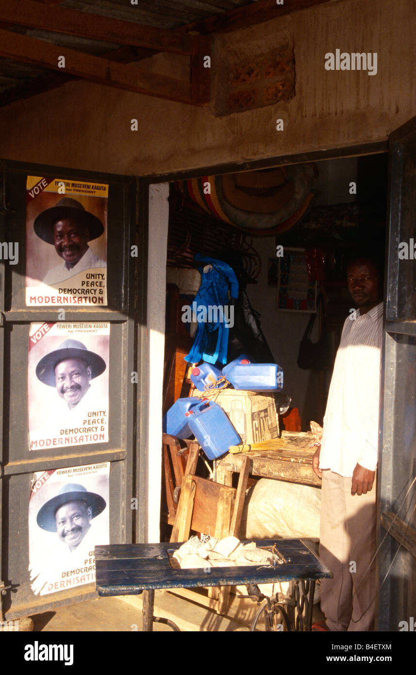 Shop keeper standing in shadow in doorway of shop. Uganda Stock Photo ...