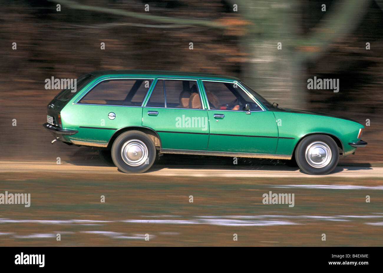 Car, Opel Rekord D 2000 Caravan, wagon, model year 1972-1977, old car,  green, driving, side view, road, country road Stock Photo