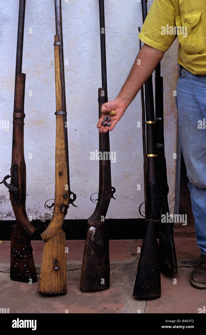 Park ranger with seized poachers guns, cropped, Gorongosa National Park