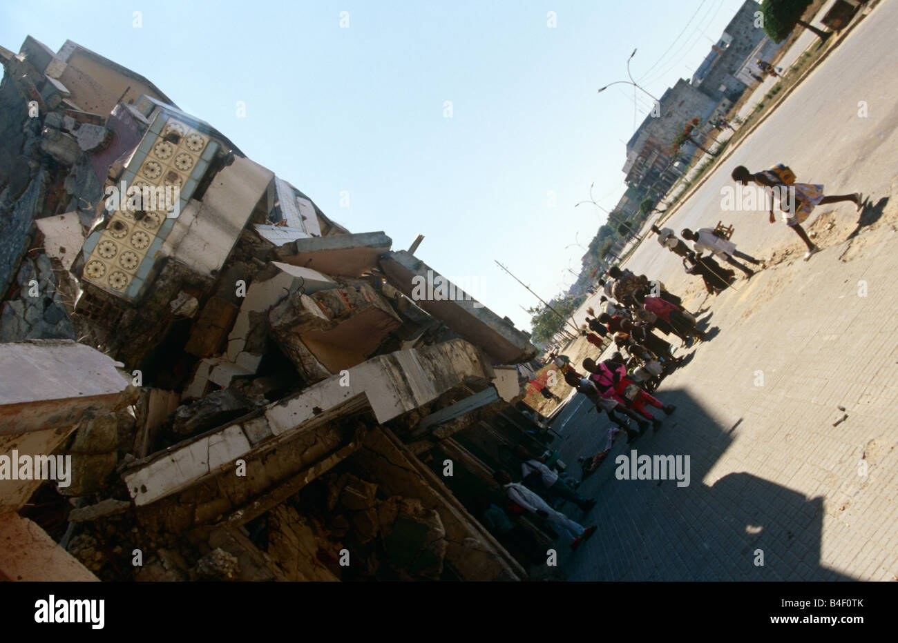 Street children sheltering by tumbling building in war-torn Angola Stock Photo