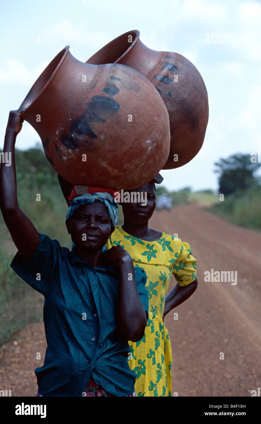 African woman carrying pot on her head hires stock photography and