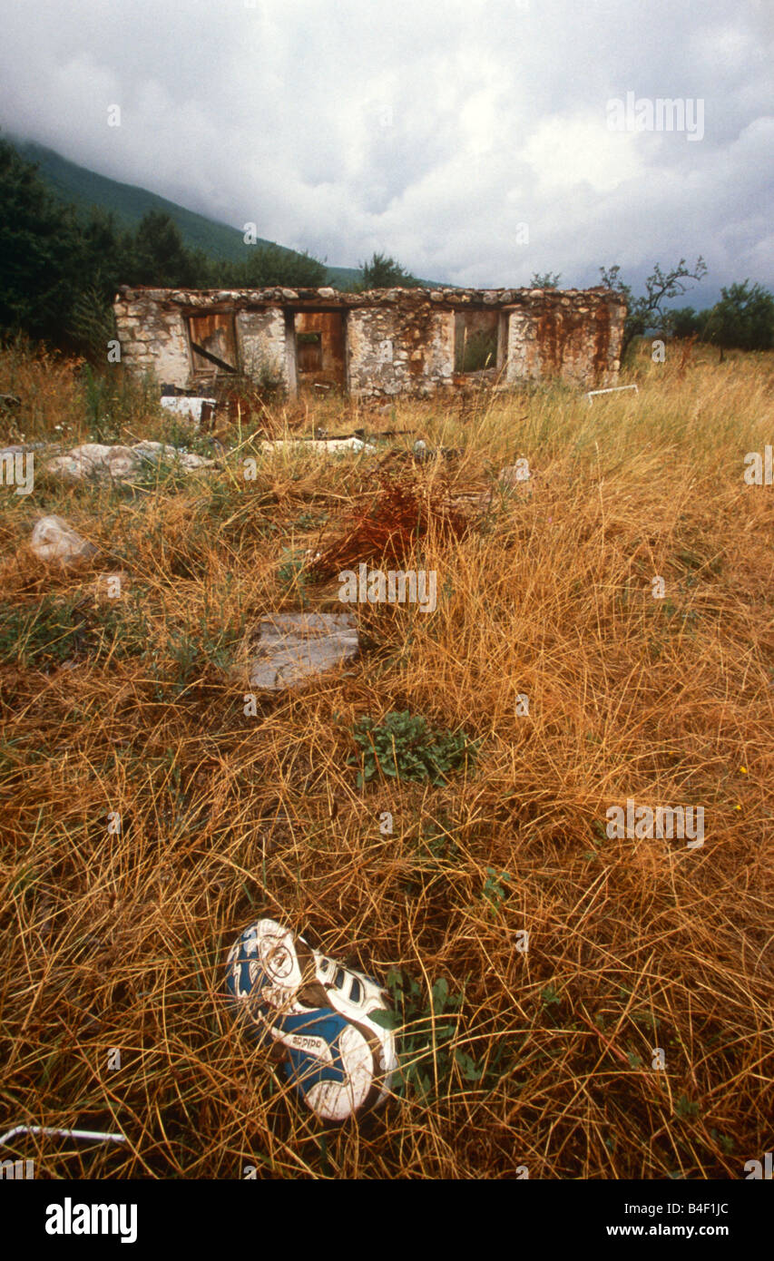 Training shoe and remains of a traditional building in rural village after Kosovo War, Kosovo, Balkans, Southeastern Europe Stock Photo