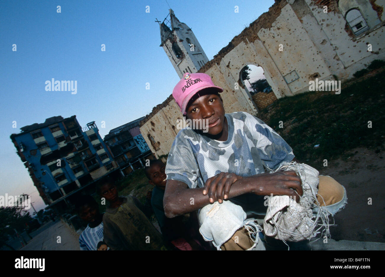 Civil war aftermath with boy in urban wasteland, Angola, Africa Stock Photo