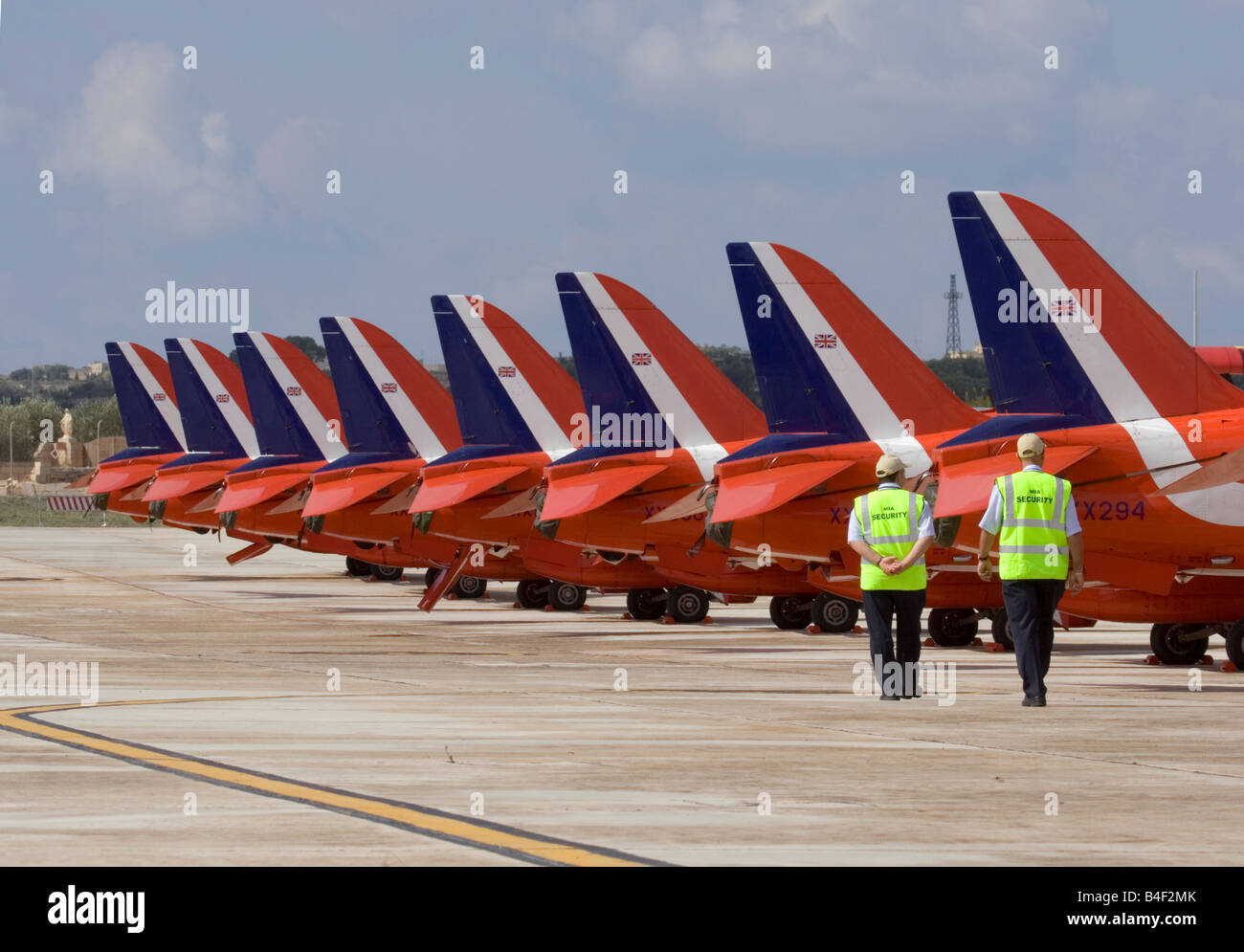 Security officers walk past the parked Red Arrows Hawks Stock Photo