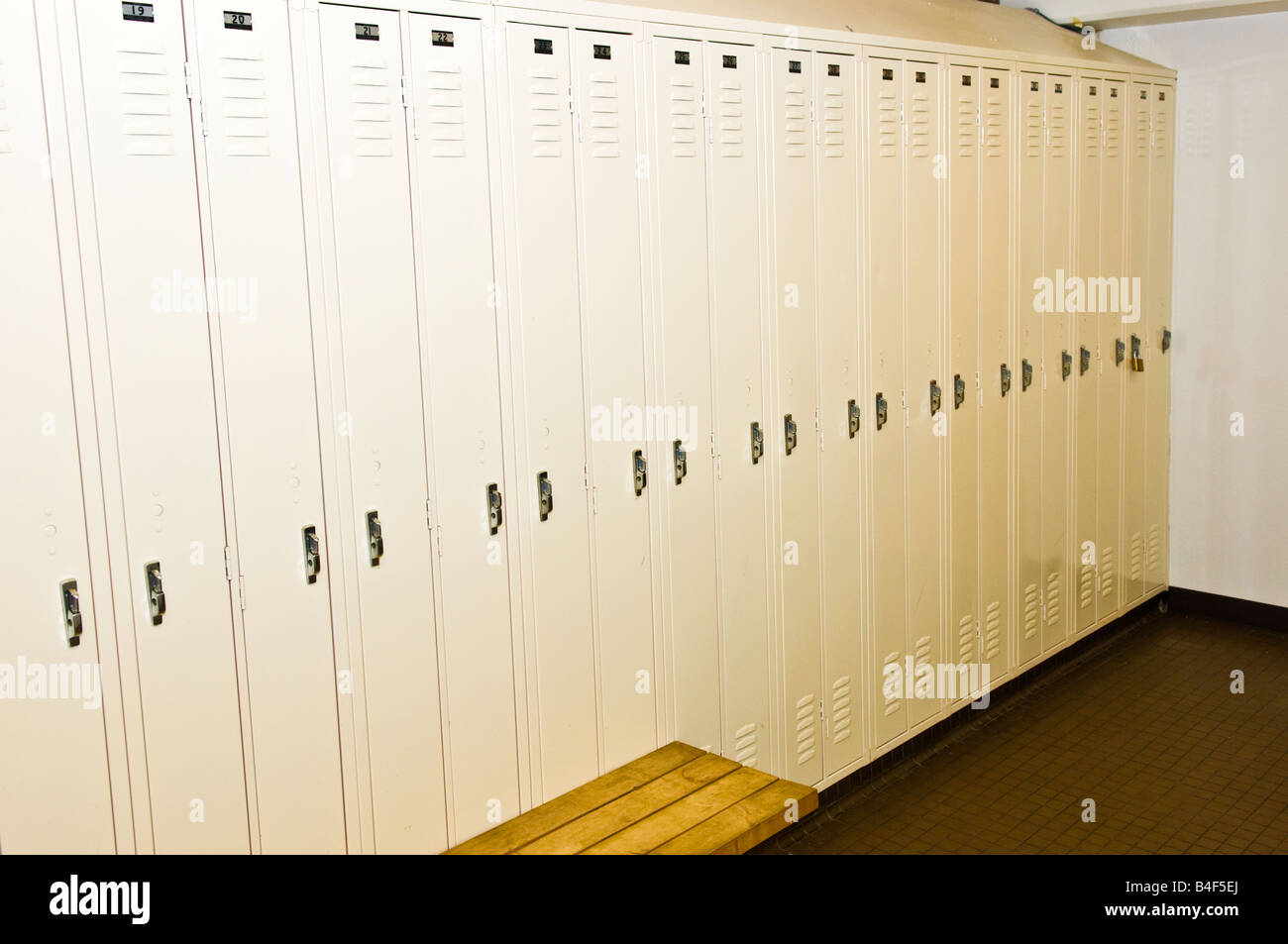 Locker room showing narrow lockers in off-white color Stock Photo