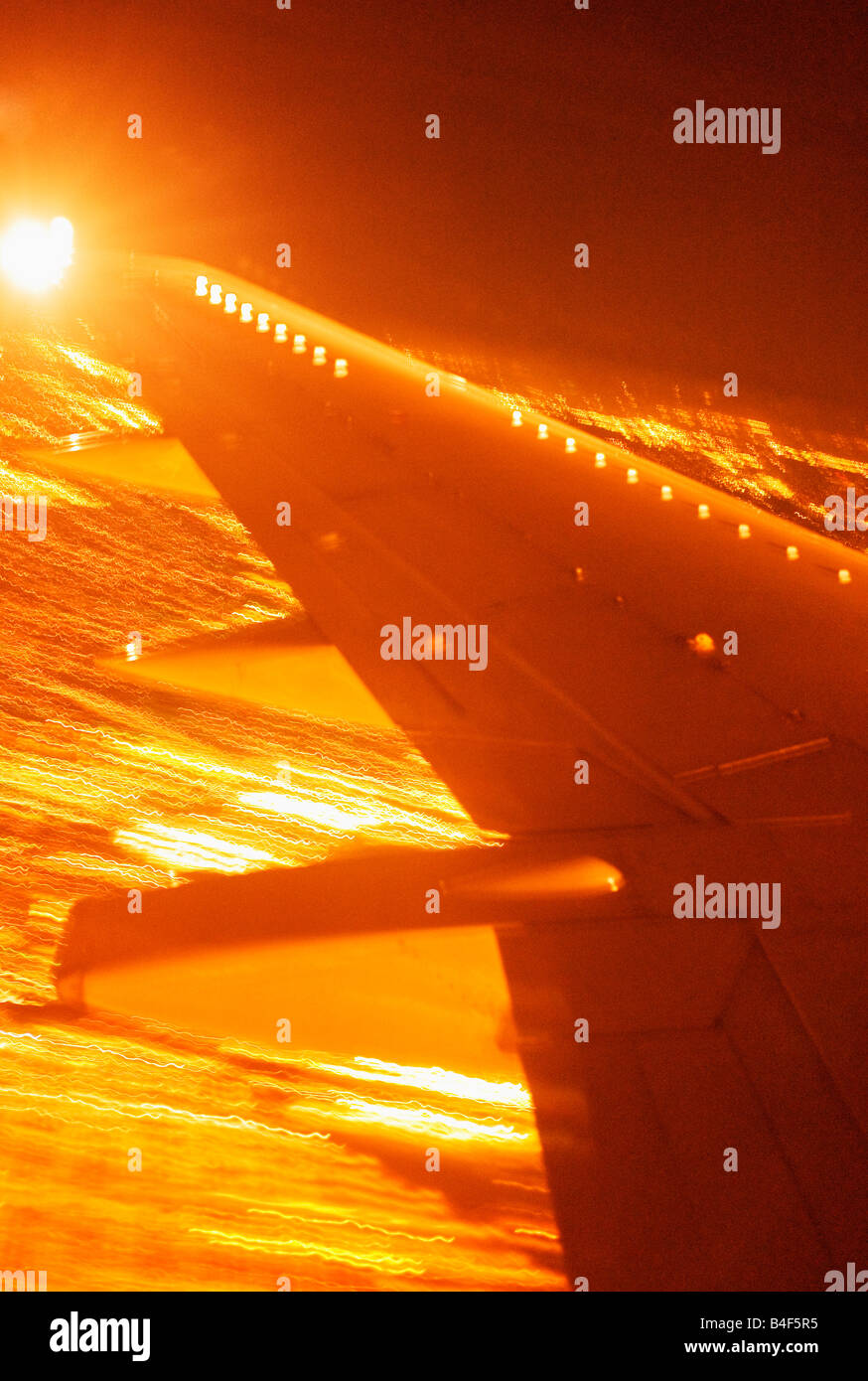 Wing of an airplane landing at night in JFK in New York City, New York, USA Stock Photo